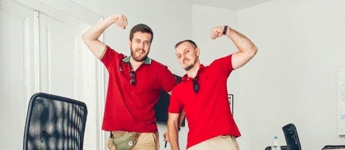 Two of the team flexing for the camera in the studio.